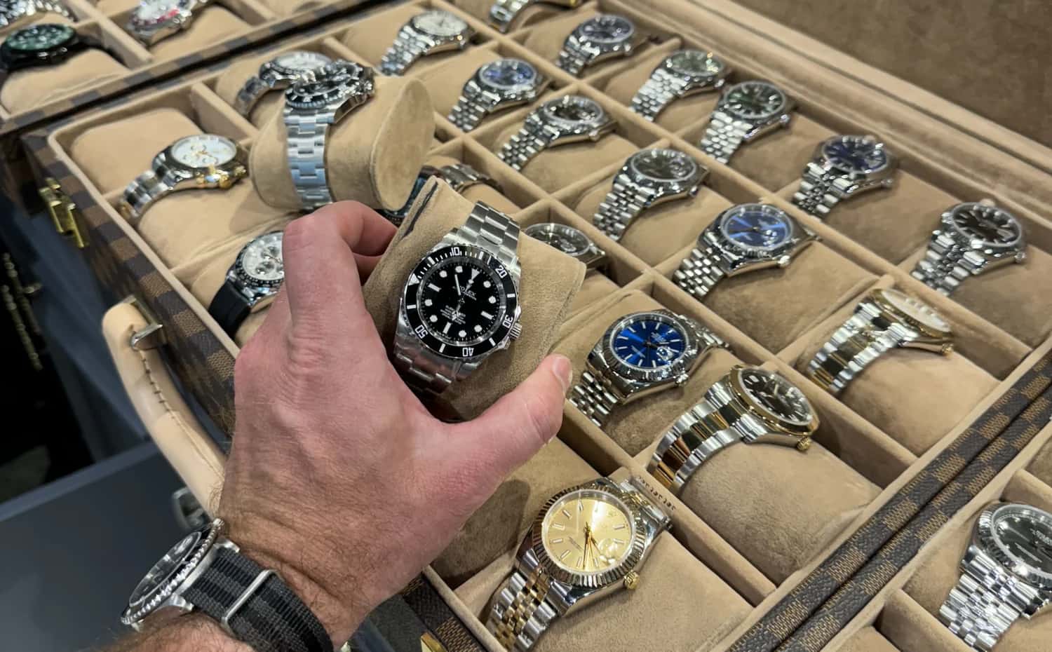 Buyer unboxing Rolex super clone with packaging and warranty card.